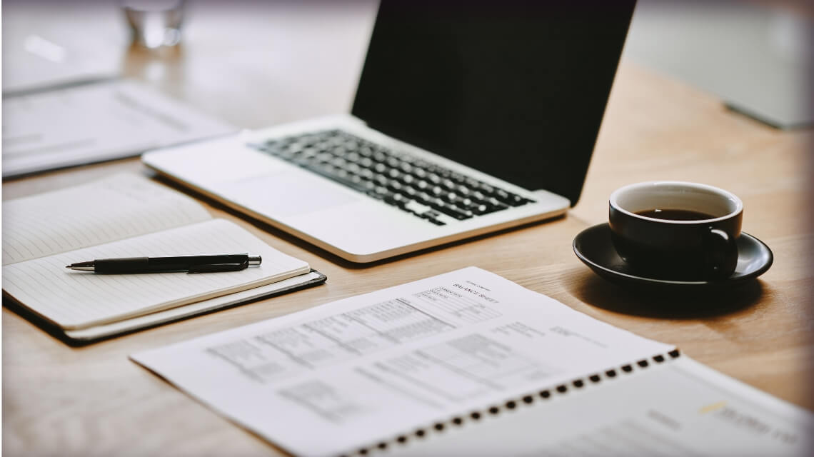 Laptop and papers on a desk