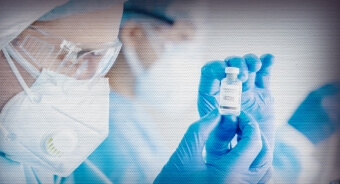 Medical professional looking at a vial of medicine