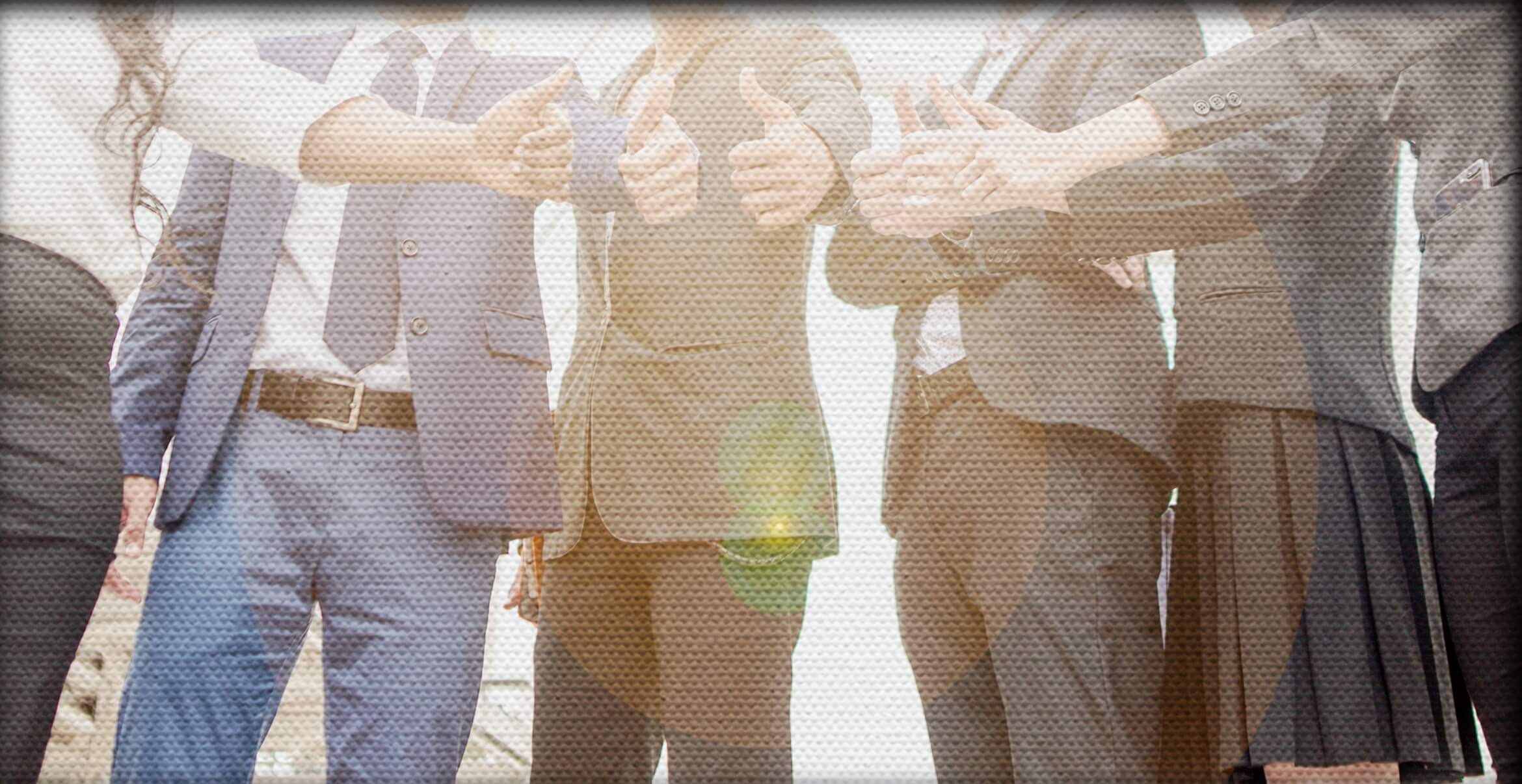 Group of business people in a half circle giving thumbs up