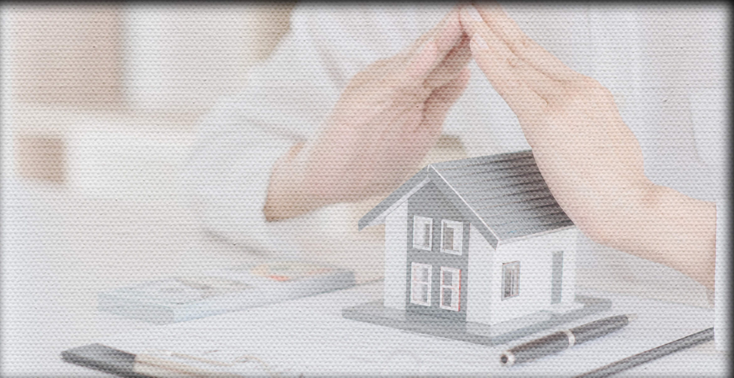 Man with hands steepled over model house